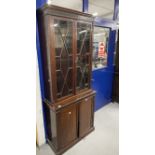 Early 20th cent. Mahogany two part bookcase, the thirteen pane glazed doors above two blind doors on