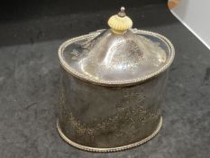 Hallmarked Silver: Tea caddy, hinged cover, engraved leaf and floral decoration. Hallmarked London