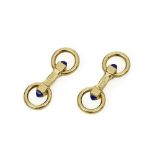 CARTIER 18K GOLD AND LAPIS LAZULI ROUND CUFFLINKS, CIRCA 1931 Designed as batons, the ends each