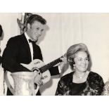 ANONYMOUS PHOTOGRAPHER Johnny Hallyday playing guitar with the Begum Aga Khan (Yvette Labrousse)