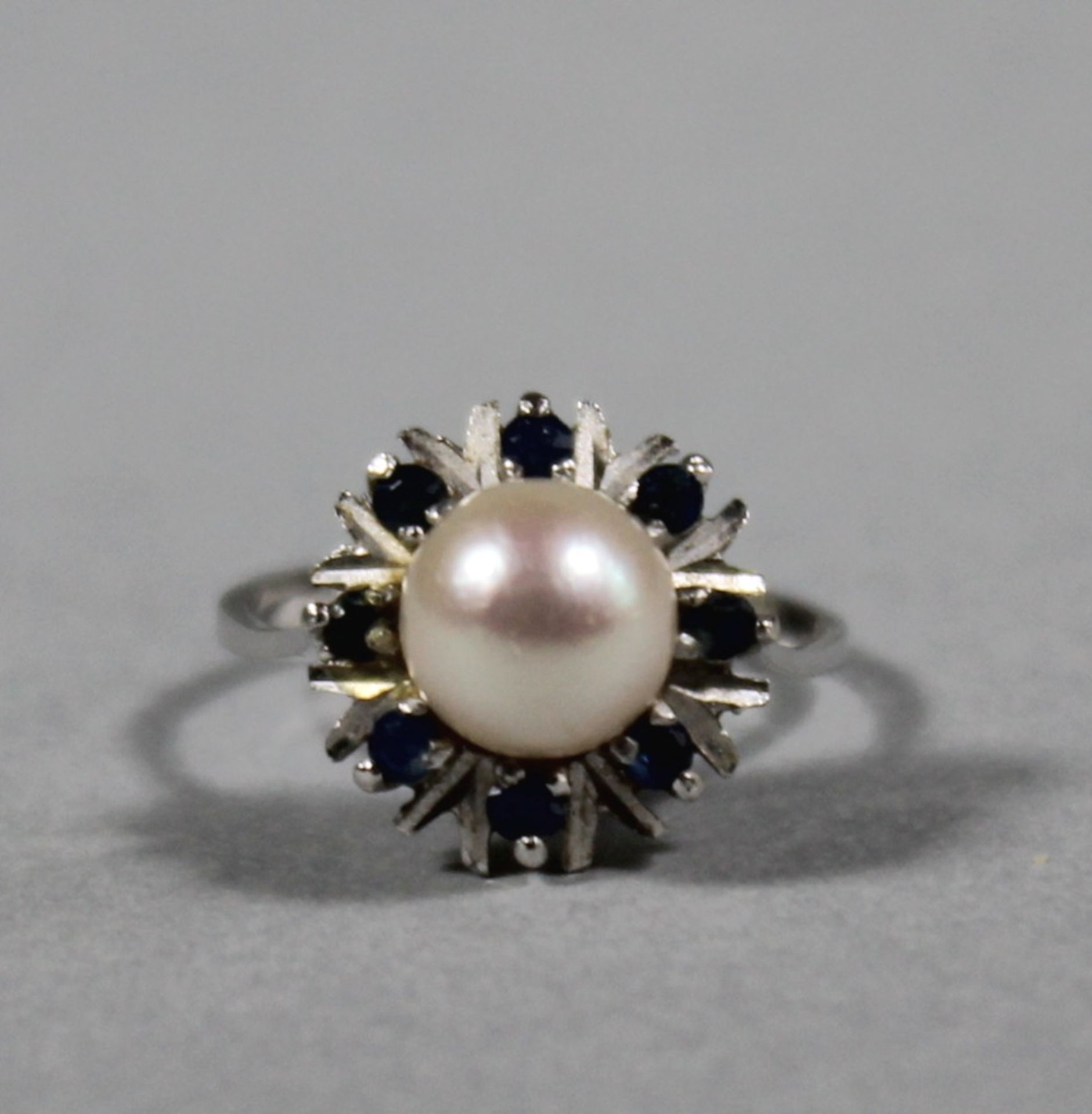 1 Ring 14kt.Wg (585/000), runder Ringkopf mittig besetzt mit weißer Perle im guten Lüster,