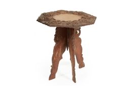AN INDIAN OCTAGONAL CARVED WOOD FOLDING TABLE
