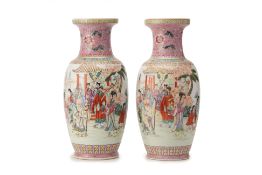 A PAIR OF PINK GROUND FAMILLE ROSE BALUSTER VASES