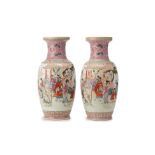 A PAIR OF PINK GROUND FAMILLE ROSE BALUSTER VASES