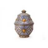 A LARGE METAL-MOUNTED MOROCCAN POTTERY JAR AND COVER