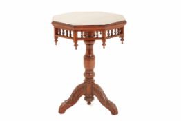 AN OCTAGONAL TEAK TRIPOD TABLE