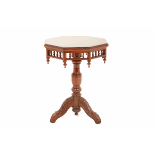 AN OCTAGONAL TEAK TRIPOD TABLE