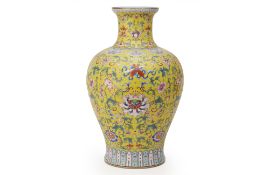 A LARGE YELLOW GROUND FAMILLE ROSE PORCELAIN VASE
