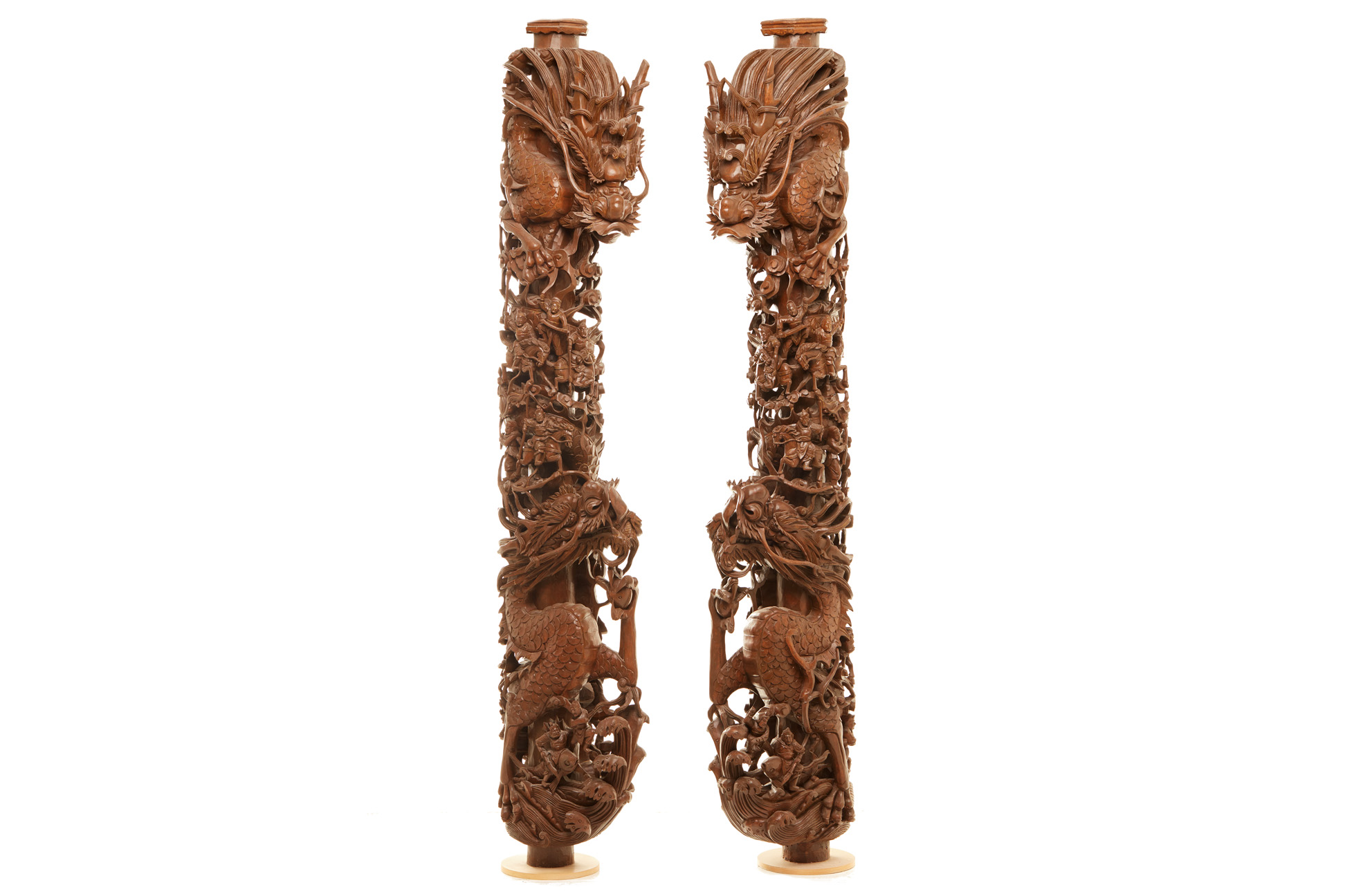 A PAIR OF LARGE CARVED WOOD 'WAR SCENE' PILLARS