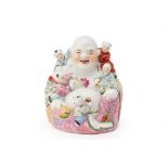 A FAMILLE ROSE PORCELAIN MODEL OF BUDAI