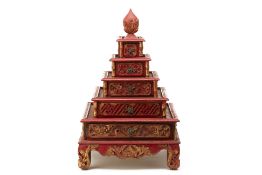 AN INDONESIAN PERANAKAN CARVED RED & GILT FIVE-TIERED BOX
