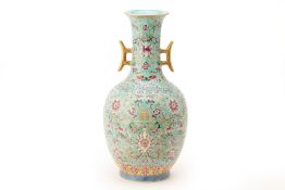 A TURQUOISE GROUND FAMILLE ROSE TWIN HANDLED VASE