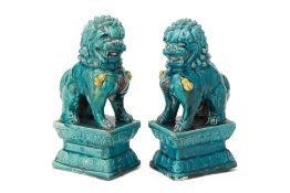 A PAIR OF TURQUOISE GLAZED FOO DOGS