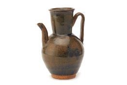 A SMALL BROWN GLAZED STONEWARE EWER