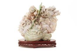 AN INTRICATE JADE CARVING OF BUDAI