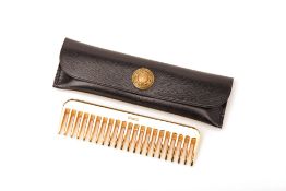 A VINTAGE HERMES BRASS MOUSTACHE COMB