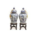 A PAIR OF LARGE BLUE & WHITE JARS AND COVERS ON STAND