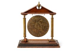 A BRASS AND OAK ARCHITECTURAL TABLE GONG