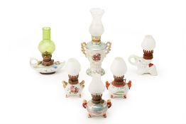 A GROUP OF SIX SMALL VINTAGE OIL LAMPS