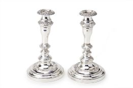 A PAIR OF ANTIQUE SILVER PLATED CANDLESTICKS