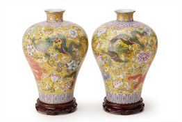 A PAIR OF FAMILLE ROSE YELLOW GROUND DRAGON VASES