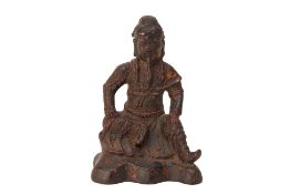 A CAST METAL MODEL OF A SEATED WARRIOR