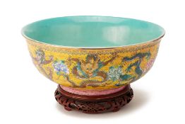 A LARGE YELLOW GROUND FAMILLE ROSE DRAGON BOWL;