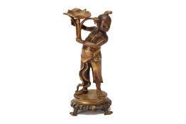 AN ORIENTAL FIGURAL CAST METAL CANDLESTICK