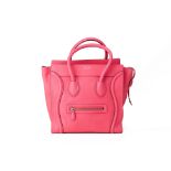 A CELINE 'MINI LUGGAGE' NEON PINK HANDBAG