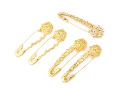 FIVE VERSACE GILT METAL SAFTEY PINS