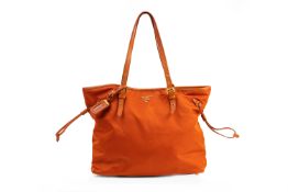 A PRADA ORANGE NYLON TOTE HANDBAG