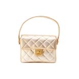 A CHANEL SMALL GOLD QUILTED FLAP BAG WITH TOP HANDLE