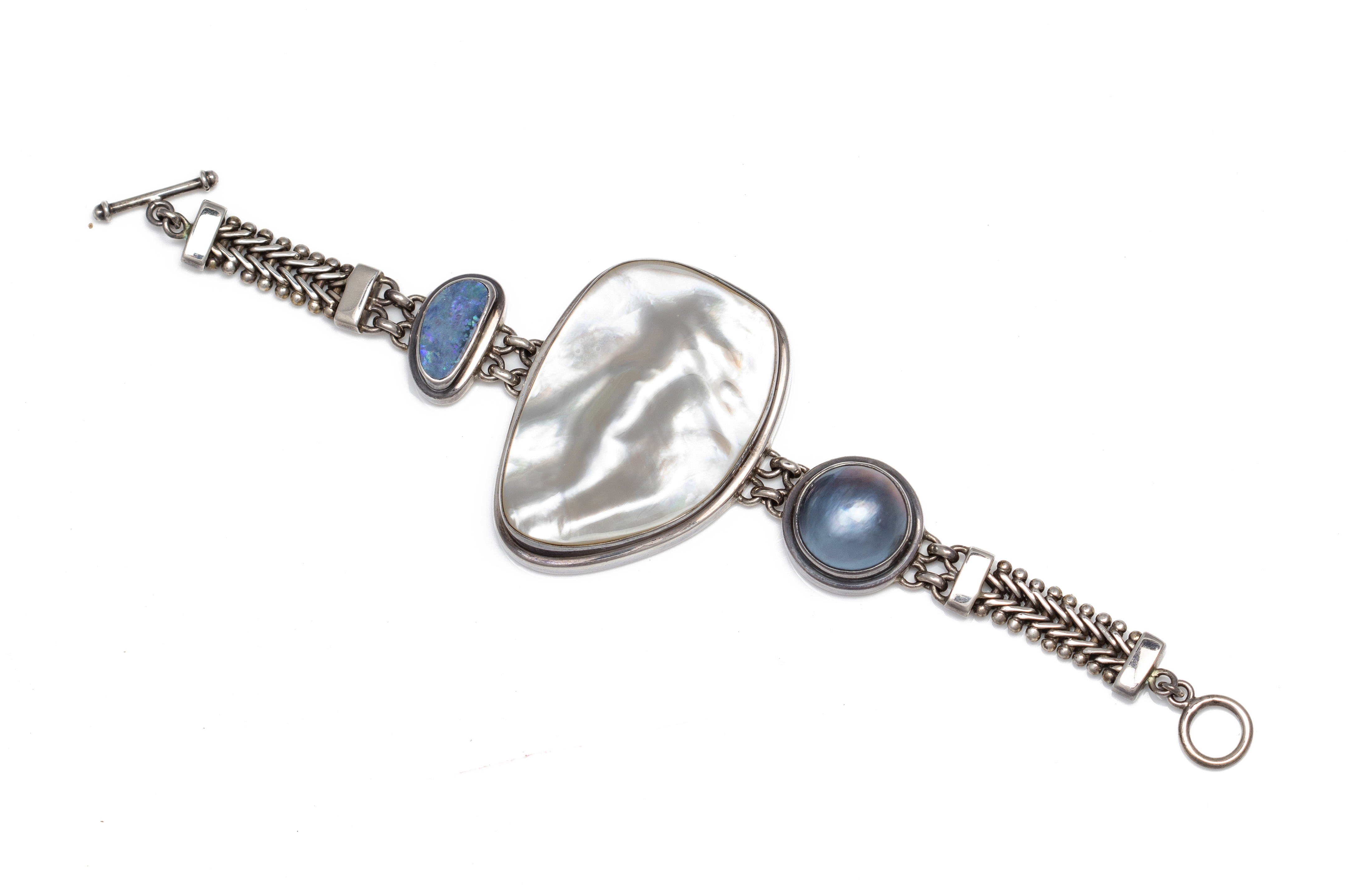 A MOTHER OF PEARL AND GEM SILVER BRACELET