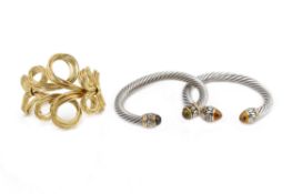 TWO OPEN CUFF BRACELETS AND A GOLD-TONE BANGLE