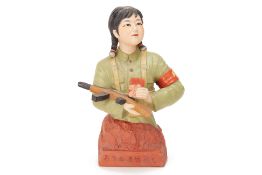 A PORCELAIN MODEL OF A CHINESE FEMALE SOLDIER