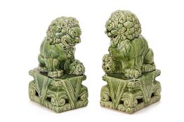 A PAIR OF GREEN GLAZED BUDDHIST TEMPLE LIONS