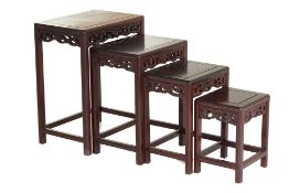 A NEST OF FOUR CHINESE CARVED HARDWOOD TABLES