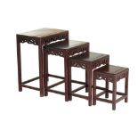 A NEST OF FOUR CHINESE CARVED HARDWOOD TABLES