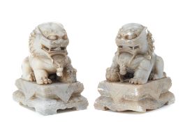 A PAIR OF CARVED SOAPSTONE FOO DOGS