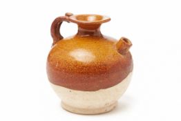 A SMALL BROWN-GLAZED GLOBULAR POTTERY EWER