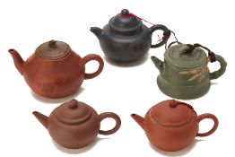 A GROUP OF FIVE CHINESE POTTERY TEAPOTS