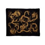 A LARGE BLACK AND GOLD EMBROIDERED DRAGON BED COVER