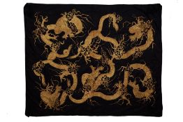 A LARGE BLACK AND GOLD EMBROIDERED DRAGON BED COVER