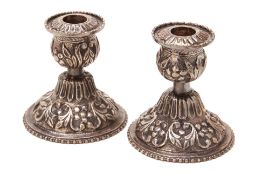 A PAIR OF MALAY SILVER CANDLESTICKS