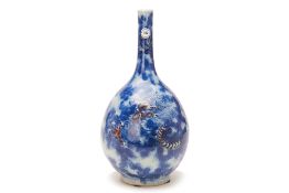 A BLUE, WHITE AND COPPER RED DRAGON BOTTLE VASE