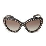 A PAIR OF PRADA STUDDED CAT EYE SUNGLASSES