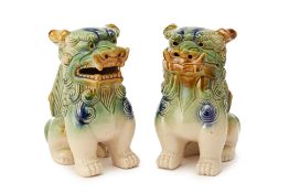 A PAIR OF GREEN GLAZED BUDDHIST TEMPLE LIONS