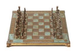 A CAST METAL CLASSICAL CHESS SET AND BOARD