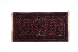 A SMALL AFGHAN WOOL RUG