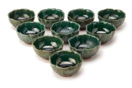 TEN GREEN GLAZED POTTERY BOWLS